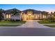 An elegant home with a three-car garage, manicured lawn, and paved driveway at 9241 Starry Night Ave, Sarasota, FL 34241