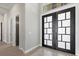 Grand foyer with contemporary double doors, marble flooring and views of the hallway at 9241 Starry Night Ave, Sarasota, FL 34241