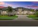 Stunning single-story home with a paver driveway, lush landscaping and modern architectural details at 9241 Starry Night Ave, Sarasota, FL 34241