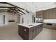 Spacious kitchen with large center island, stainless steel appliances and open concept design at 9241 Starry Night Ave, Sarasota, FL 34241