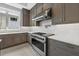 Modern kitchen featuring white countertops, tiled backsplash, and professional grade stainless steel appliances at 9241 Starry Night Ave, Sarasota, FL 34241