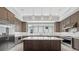 Bright kitchen boasts custom cabinetry, a center island, stainless steel appliances and generous counter space at 9241 Starry Night Ave, Sarasota, FL 34241