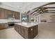 Open-concept kitchen flows into the living room and features stainless appliances, center island and custom cabinetry at 9241 Starry Night Ave, Sarasota, FL 34241