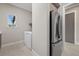 Clean laundry area with stainless steel refrigerator, washer, and dryer at 9241 Starry Night Ave, Sarasota, FL 34241