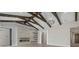 Spacious living area with fireplace, beamed ceilings and modern chandeliers at 9241 Starry Night Ave, Sarasota, FL 34241