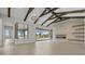 Open-concept living area with beamed ceilings, tiled floors and view to the pool and lake at 9241 Starry Night Ave, Sarasota, FL 34241