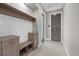 Inviting mudroom with built-in bench, cubbies, and storage cabinets adjacent to exterior door at 9241 Starry Night Ave, Sarasota, FL 34241