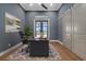 Stylish home office featuring a modern desk, sliding barn doors, and neutral paint at 9241 Starry Night Ave, Sarasota, FL 34241