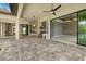 A covered outdoor living space complete with an outdoor kitchen area and grey pavers at 9241 Starry Night Ave, Sarasota, FL 34241