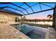 A stunning pool area with a spa, screened enclosure and lake view at 9241 Starry Night Ave, Sarasota, FL 34241