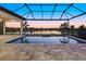 Gorgeous pool area with screened enclosure and a lovely sunset lake view at 9241 Starry Night Ave, Sarasota, FL 34241
