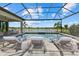 An outdoor area features a luxurious in-ground pool and spa with lounge chairs nearby at 9241 Starry Night Ave, Sarasota, FL 34241