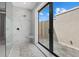 Modern walk-in shower with a built-in bench and access to private outdoor area at 9241 Starry Night Ave, Sarasota, FL 34241