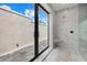 Modern walk-in shower with a built-in bench and access to private outdoor area at 9241 Starry Night Ave, Sarasota, FL 34241