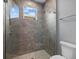 Tile shower with glass enclosure, overhead shower and integrated seat at 9241 Starry Night Ave, Sarasota, FL 34241
