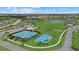 Aerial view of tennis and basketball courts offer residents a variety of recreational options at 9241 Starry Night Ave, Sarasota, FL 34241