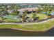 Aerial view of community clubhouse, pool, and recreational areas by the lake at 9914 Craftsman Park Way, Palmetto, FL 34221