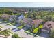 Aerial view of homes in a well-kept neighborhood with palm trees and sidewalks at 9914 Craftsman Park Way, Palmetto, FL 34221