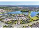 Extensive aerial view showcasing community amenities, lakes, clubhouse, pools, tennis courts, and ample parking at 9914 Craftsman Park Way, Palmetto, FL 34221