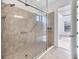 Modern bathroom featuring glass enclosed shower with tile surround and modern fixtures at 9914 Craftsman Park Way, Palmetto, FL 34221
