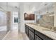 Elegant bathroom with double vanity, granite countertop, and walk-in shower at 9914 Craftsman Park Way, Palmetto, FL 34221