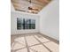 Bedroom features a ceiling fan and tray ceiling over wood-look floors with sunlit window views at 9914 Craftsman Park Way, Palmetto, FL 34221