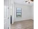 Clean bedroom with a view to the bathroom and featuring wood-look flooring at 9914 Craftsman Park Way, Palmetto, FL 34221