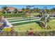 Well-manicured bocce ball courts with lush landscaping, hedges, and palm trees provide recreational activity at 9914 Craftsman Park Way, Palmetto, FL 34221