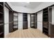 Walk-in closet with dark wood shelving and ample storage space at 9914 Craftsman Park Way, Palmetto, FL 34221
