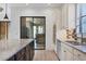 Spacious kitchen featuring a large island, stainless steel appliances, and sliding glass doors at 9914 Craftsman Park Way, Palmetto, FL 34221