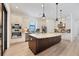 Bright kitchen featuring a large island, stainless steel appliances, and white cabinets at 9914 Craftsman Park Way, Palmetto, FL 34221