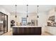Modern kitchen with white cabinets, stainless steel appliances, a central island, and pendant lighting at 9914 Craftsman Park Way, Palmetto, FL 34221