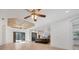 Open-concept living room featuring hardwood floors, and an island kitchen with modern pendant lighting at 9914 Craftsman Park Way, Palmetto, FL 34221