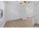 Inviting living room with wood floors, bright white walls, double french doors, and great natural light at 9914 Craftsman Park Way, Palmetto, FL 34221