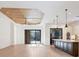 Bright living room with open floor plan, hardwood floors, and a view of the outdoor patio at 9914 Craftsman Park Way, Palmetto, FL 34221