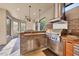 Outdoor kitchen with stainless steel appliances, a brick surround, sink, and ample countertop space at 9914 Craftsman Park Way, Palmetto, FL 34221