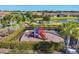 Brightly colored community playground with slides and climbing equipment surrounded by mature landscaping at 9914 Craftsman Park Way, Palmetto, FL 34221