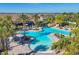 Community swimming pool surrounded by palm trees, lounge chairs, and manicured grounds at 9914 Craftsman Park Way, Palmetto, FL 34221