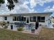 Outdoor patio area with a dining table, chairs, grill, and landscaping at 1007 Pussywillow Ln, Bradenton, FL 34208
