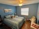 Bright bedroom featuring a full size bed, wood floors, and neutral walls at 1007 Pussywillow Ln, Bradenton, FL 34208