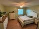 Comfortable bedroom featuring a queen bed, wood floors, two dressers, and a ceiling fan at 1007 Pussywillow Ln, Bradenton, FL 34208