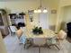 Bright dining area featuring tiled floor, a table set for five, and a built-in desk at 1007 Pussywillow Ln, Bradenton, FL 34208