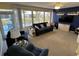 Bright sun room featuring a large picture window, a comfortable sofa, and a wall-mounted television at 1007 Pussywillow Ln, Bradenton, FL 34208