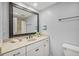 Bathroom showcasing a large framed mirror, vanity with sink, and nautical decorative accents at 107 Nippino W Trl, Nokomis, FL 34275