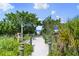 Picturesque path leading to the beach surrounded by lush greenery at 107 Nippino W Trl, Nokomis, FL 34275