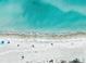 Aerial view of a pristine beach with crystal-clear turquoise waters at 107 Nippino W Trl, Nokomis, FL 34275