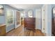Bright bedroom boasting wood floors, blue walls, and shuttered windows that complement the natural light at 107 Nippino W Trl, Nokomis, FL 34275