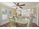 Bright dining room with wood floors, elegant furnishings, and ample natural light at 107 Nippino W Trl, Nokomis, FL 34275