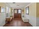 Bright foyer with wood floors, paneled walls, and elegant double doors at 107 Nippino W Trl, Nokomis, FL 34275