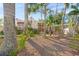 Inviting home exterior with lush landscaping and a charming front porch at 107 Nippino W Trl, Nokomis, FL 34275